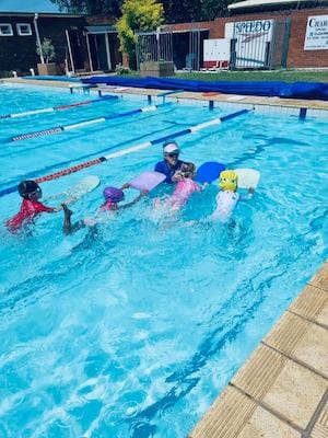 Children swimming with kickboards