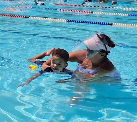 Instructor with child in pool